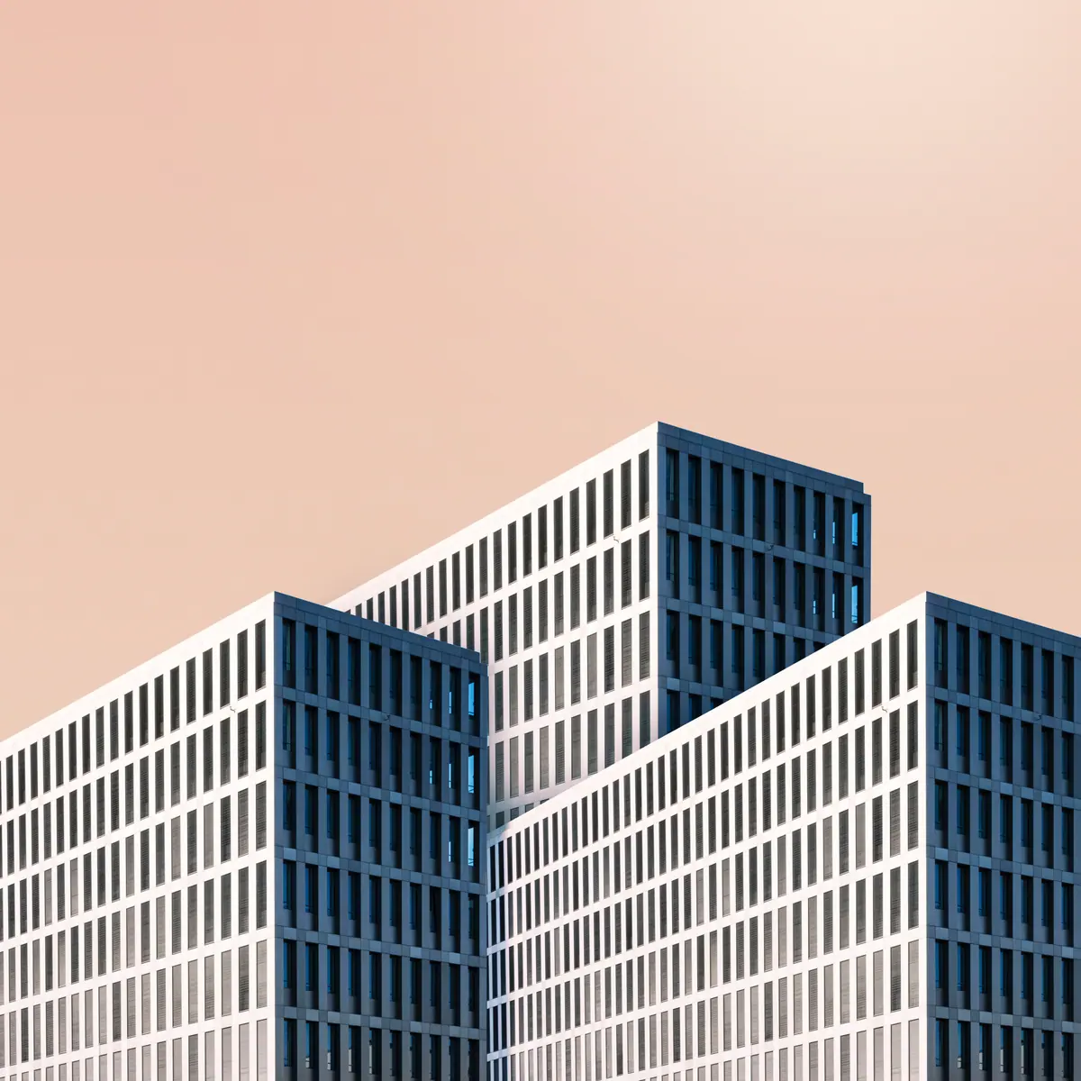 Stepped white facades and a peach-coloured sky