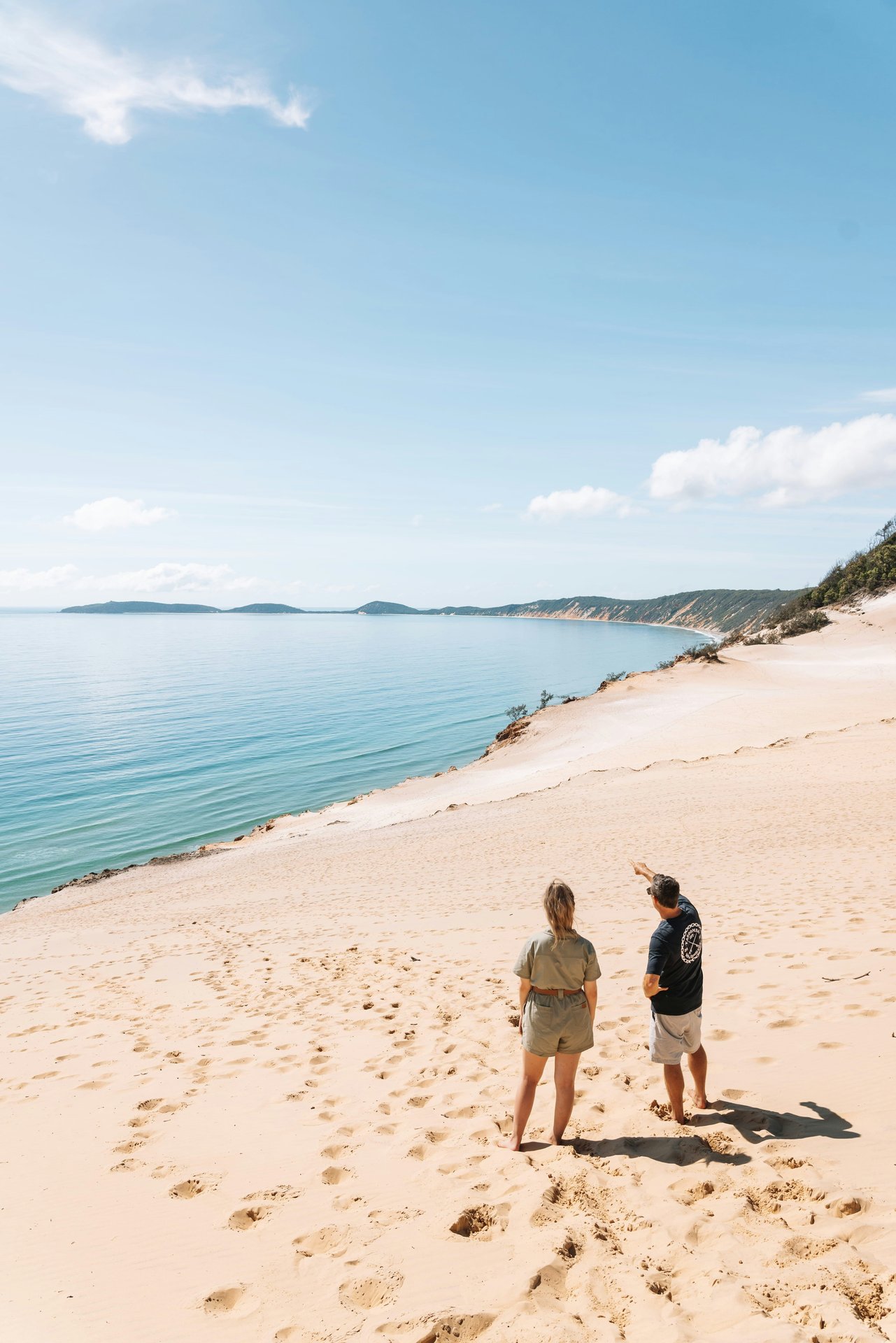 A peaceful sandy shoreline beside calm water