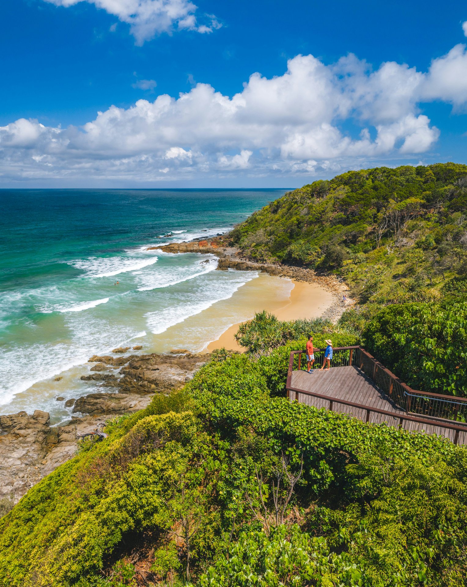A coastal boardwalk above a Queensland beach