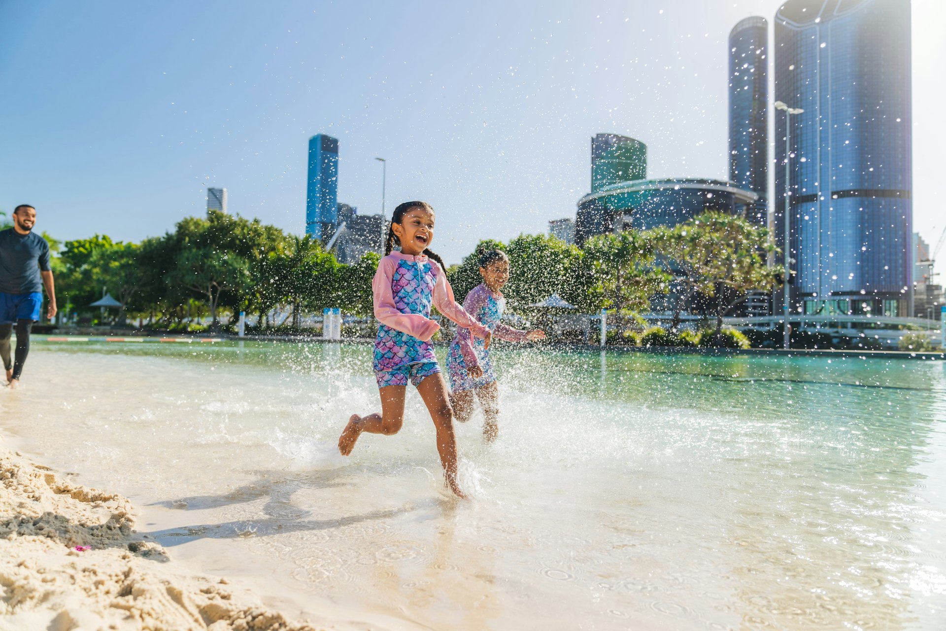 A child cooling off in an outdoor water play area